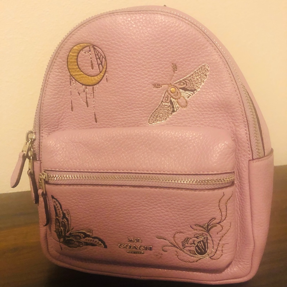 Purple coach mini backpack.